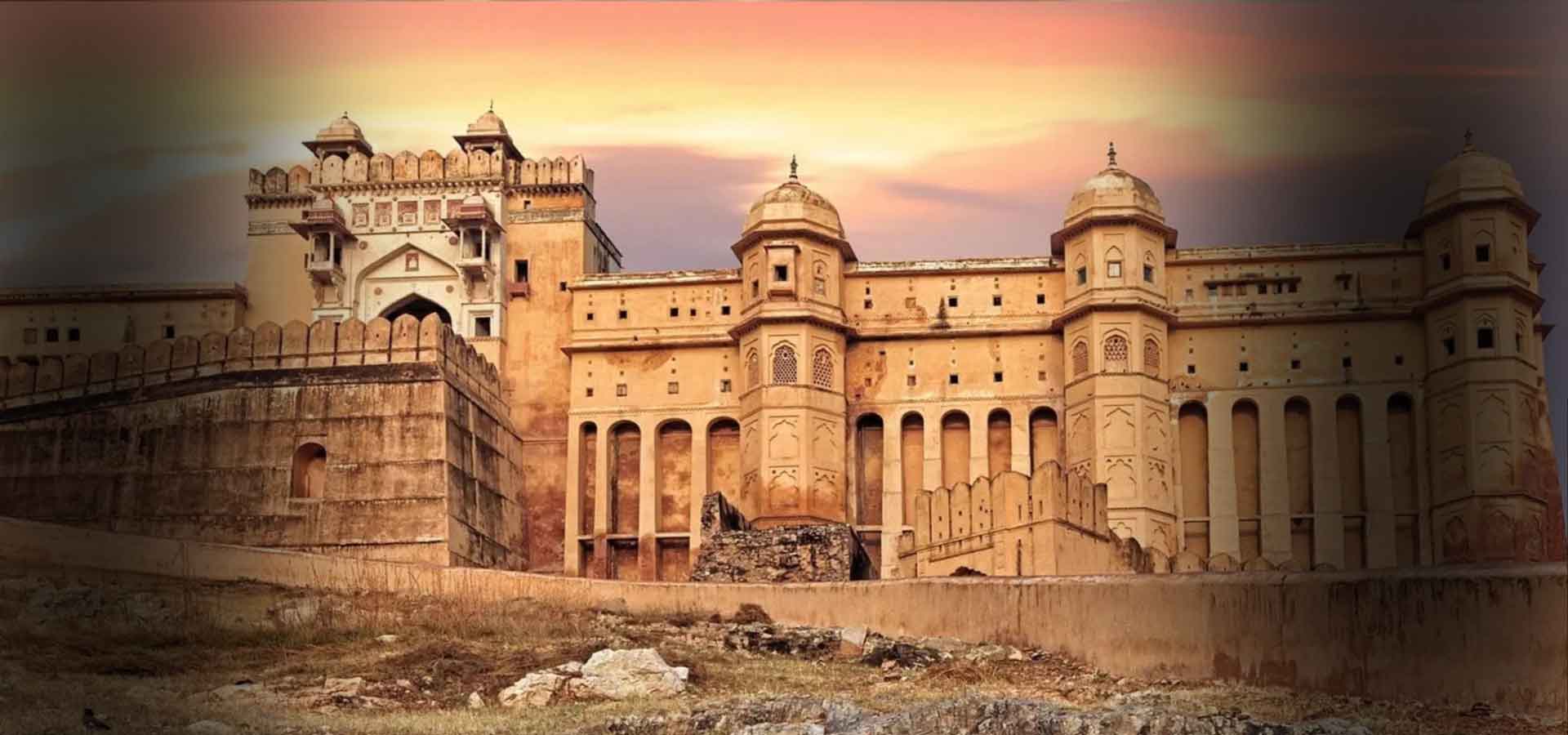 Tourist car driving past a Rajasthan hilltop fort at golden hour